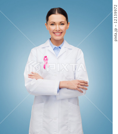 smiling female doctor with cancer awareness ribbon smiling female doctor with cancer awareness ribbon 12139972