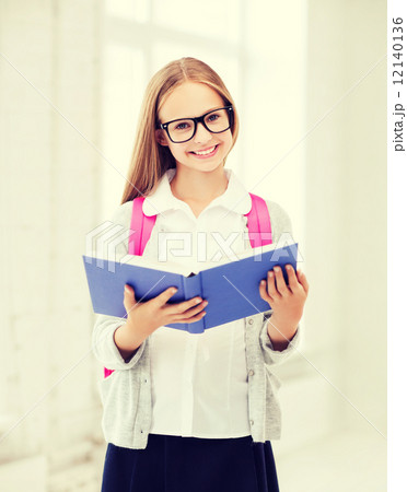 girl reading book at school 12140136
