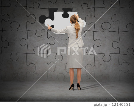 businessman in suit setting piece of puzzle 12140551