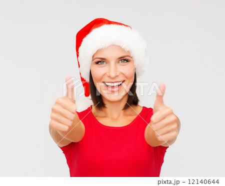 woman in santa helper hat showing thumbs up 12140644