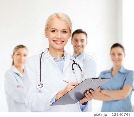 smiling female doctor with clipboard 12140745