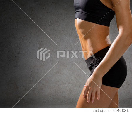 close up of athletic female abs in sportswear 12140881