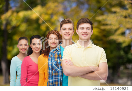 group of smiling teenagers over green park 12140922