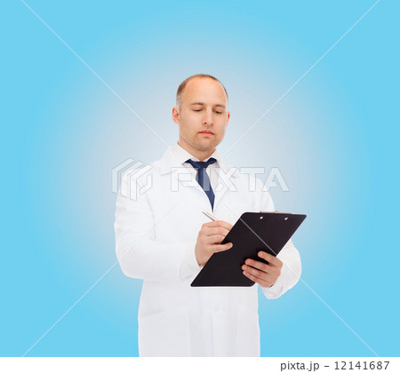 serious male doctor with clipboard 12141687