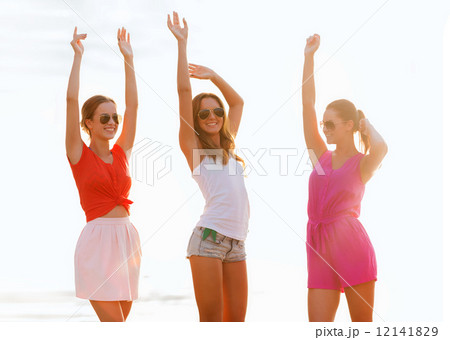 group of smiling women dancing on beach group of smiling women dancing on beach 12141829
