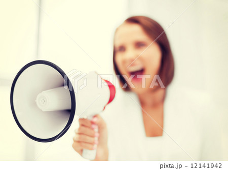 strict businesswoman shouting in megaphone strict businesswoman shouting in megaphone 12141942