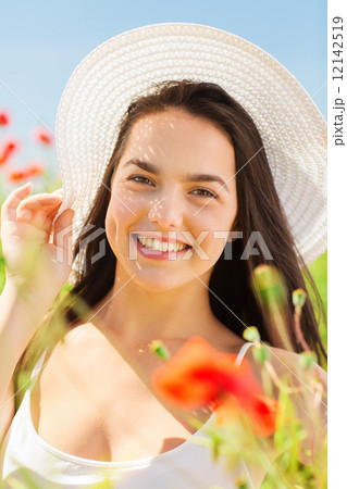 smiling young woman in straw hat on poppy field smiling young woman in straw hat on poppy field 12142519