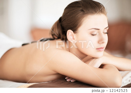woman in spa salon with hot stones 12142525