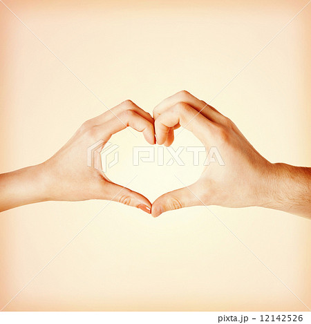 woman and man hands showing heart shape 12142526