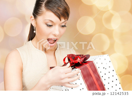 smiling woman in red dress with gift box smiling woman in red dress with gift box 12142535