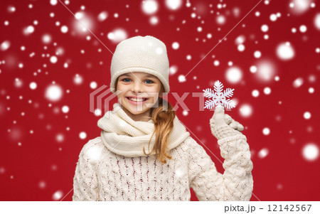 smiling girl in winter clothes with big snowflake smiling girl in winter clothes with big snowflake 12142567