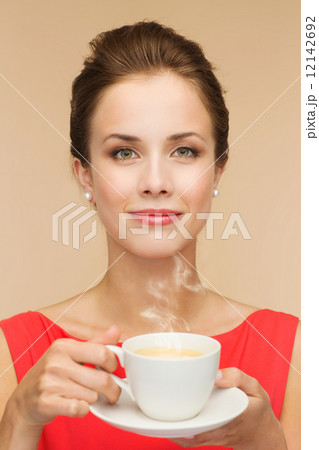 smiling woman in red dress with cup of coffee smiling woman in red dress with cup of coffee 12142692