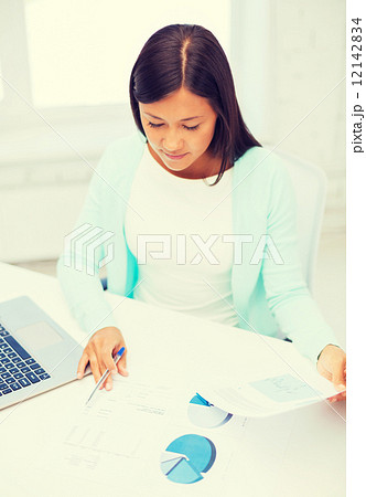 businesswoman or student with laptop and documents businesswoman or student with laptop and documents 12142834