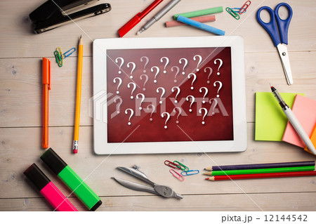 Composite image of digital tablet on students desk Composite image of digital tablet on students desk 12144542
