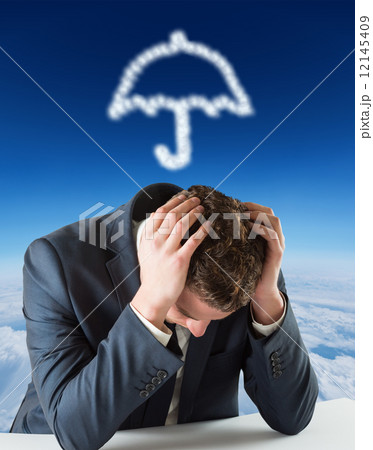 Composite image of businessman with head in hands 12145409