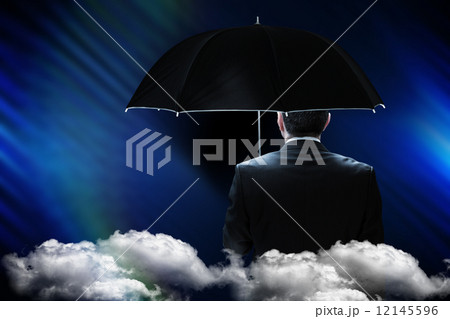 Composite image of mature businessman holding an umbrella 12145596