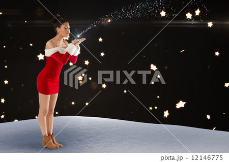Composite image of pretty santa girl blowing over her hands 12146775