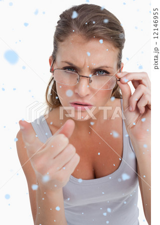 Composite image of portrait of a serious woman with glasses poin Composite image of portrait of a serious woman with glasses poin 12146955