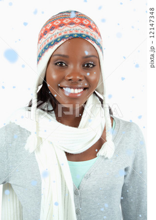 Composite image of smiling young woman in winter clothes 12147348