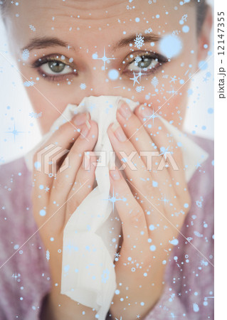 Composite image of unhappy young woman suffering from cold Composite image of unhappy young woman suffering from cold 12147355