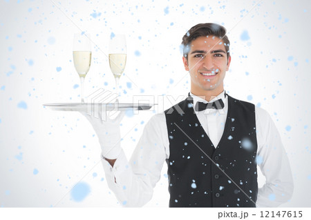 Composite image of smiling attractive waiter holding a tray with 12147615