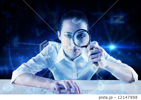Composite image of businesswoman typing and looking through magn Composite image of businesswoman typing and looking through magn 12147998