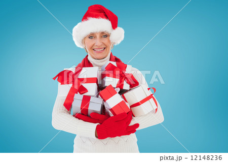 Composite image of festive woman holding gifts 12148236