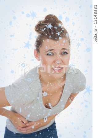 Composite image of young woman suffering from stomach pain 12148381