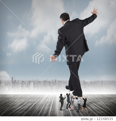 Composite image of business team supporting boss Composite image of business team supporting boss 12148535