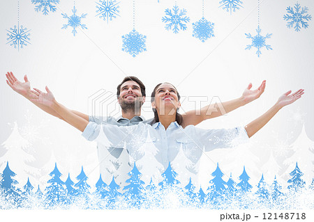 Composite image of cute couple standing with arms out 12148718
