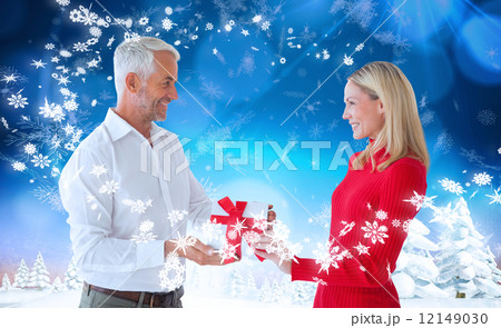 Composite image of loving couple with gift 12149030