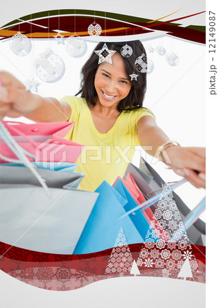 Composite image of highangle view of a young woman showing shopp Composite image of highangle view of a young woman showing shopp 12149087