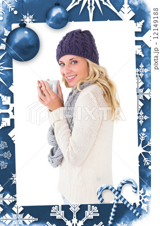 Composite image of pretty blonde in winter fashion holding mug 12149188