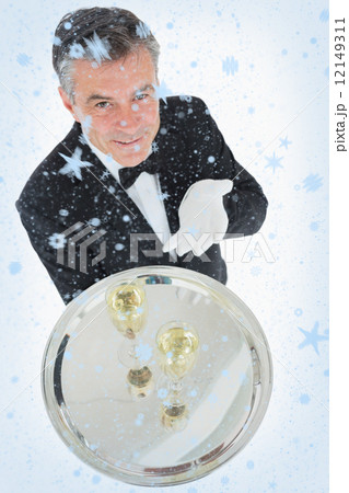 Waiter offering tray with glasses of champagne Waiter offering tray with glasses of champagne 12149311