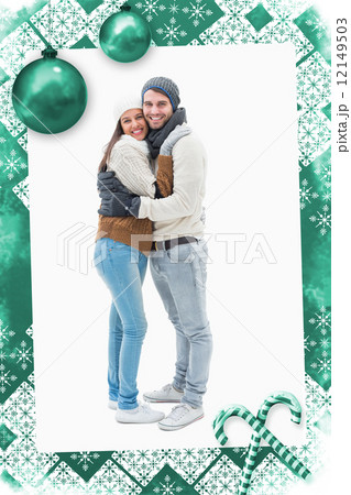 Composite image of attractive young couple in warm clothes hugging 12149503