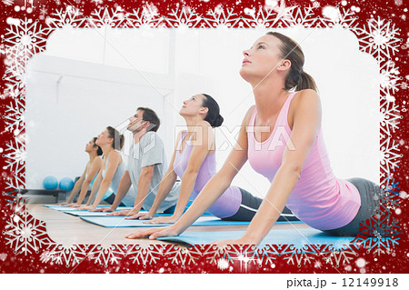 Class exercising in row at fitness studio 12149918