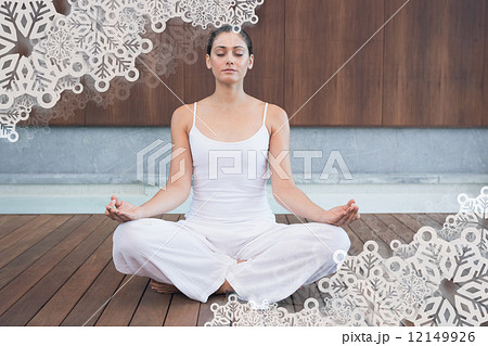 Peaceful woman in white sitting in lotus pose 12149926
