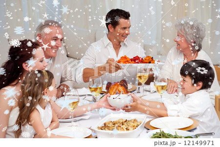 Composite image of family having a big dinner at home 12149971