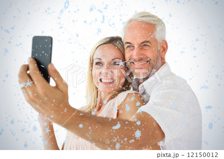 Happy couple posing for a selfie 12150012