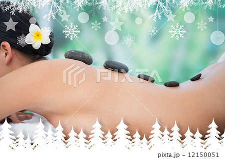 Beautiful brunette enjoying a hot stone massage 12150051