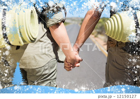 Hitch hiking couple standing holding hands on the road Hitch hiking couple standing holding hands on the road 12150127