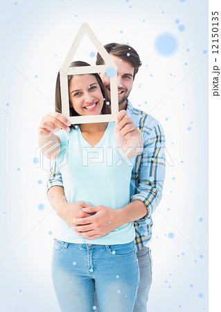 Happy young couple with house shape Happy young couple with house shape 12150135