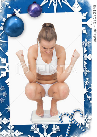 Composite image of successful young woman crouching on a scales Composite image of successful young woman crouching on a scales 12150148