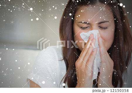 Composite image of brunette blowing nose into tissue Composite image of brunette blowing nose into tissue 12150358