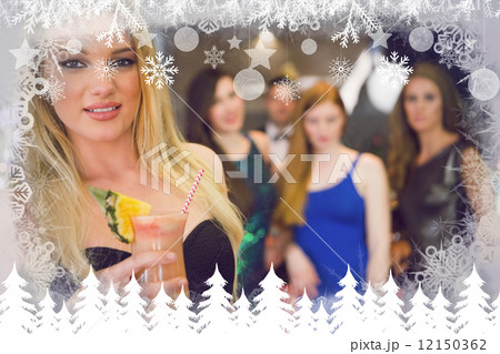 Composite image of blonde woman standing in front of her friends 12150362