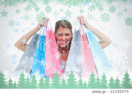Joyful woman holding shopping bags 12150374
