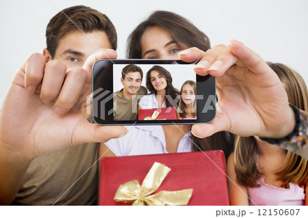 Composite image of hand holding smartphone showing Composite image of hand holding smartphone showing 12150607