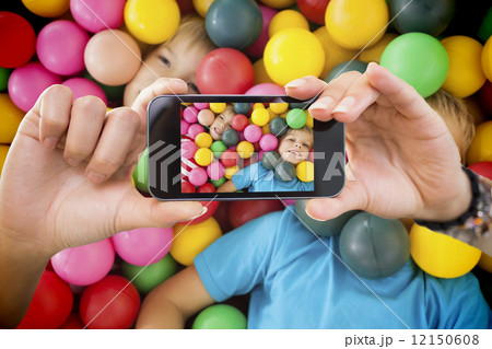 Composite image of hand holding smartphone showing 12150608