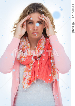 Blonde woman touching her temples because of a headache Blonde woman touching her temples because of a headache 12150611