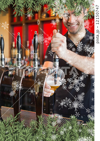 Composite image of handsome barkeeper pulling a pint of beer 12150747